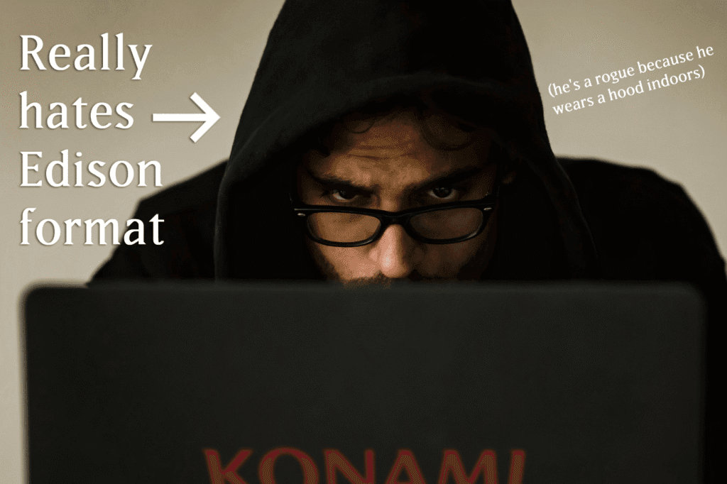 Man in a hood sitting in front of a Konami branded logo. Text reading "Really hates Edison format" and an arrow pointing to the man.
